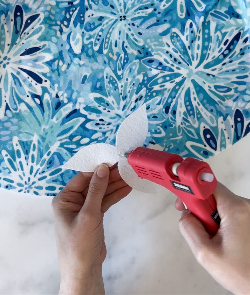 Hot glueing felt flower to tree skirt
